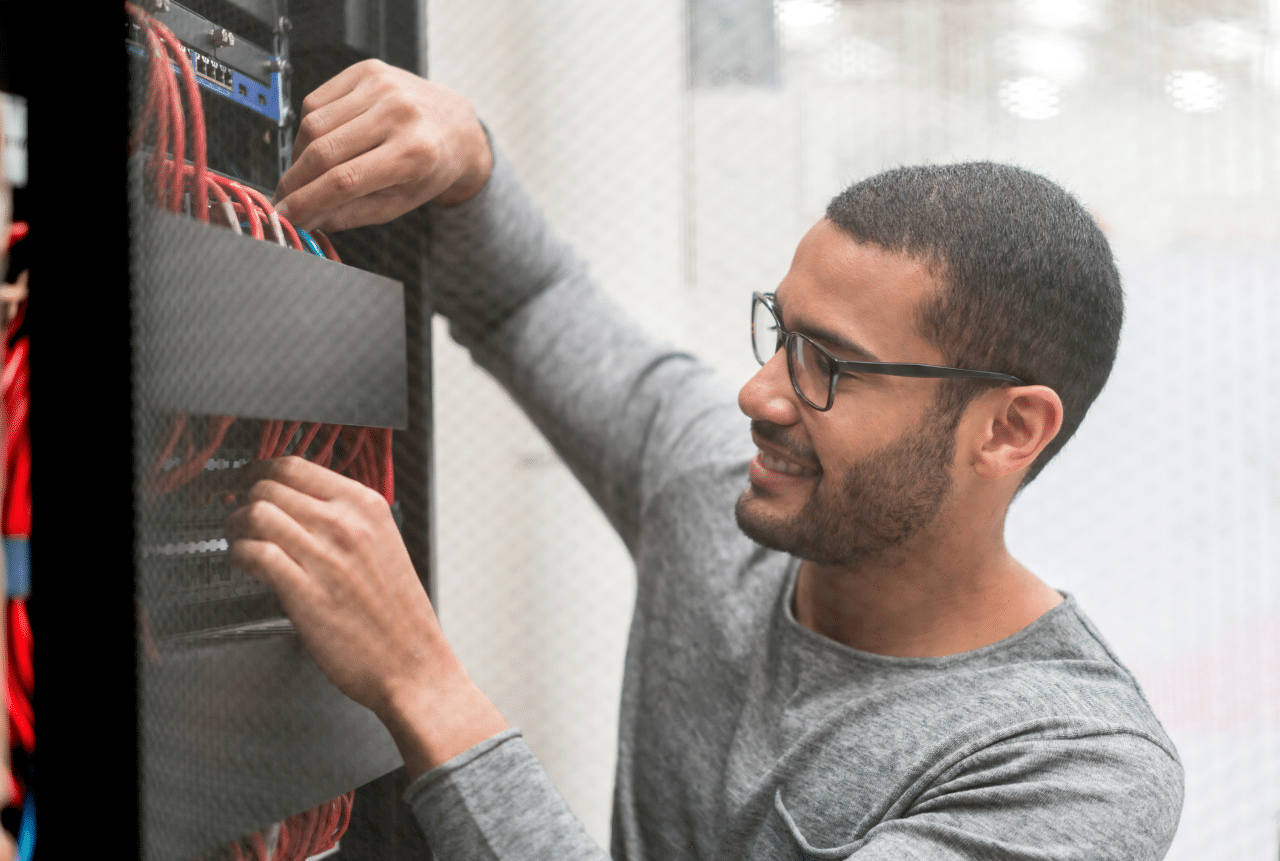 An engineer installing network equipment