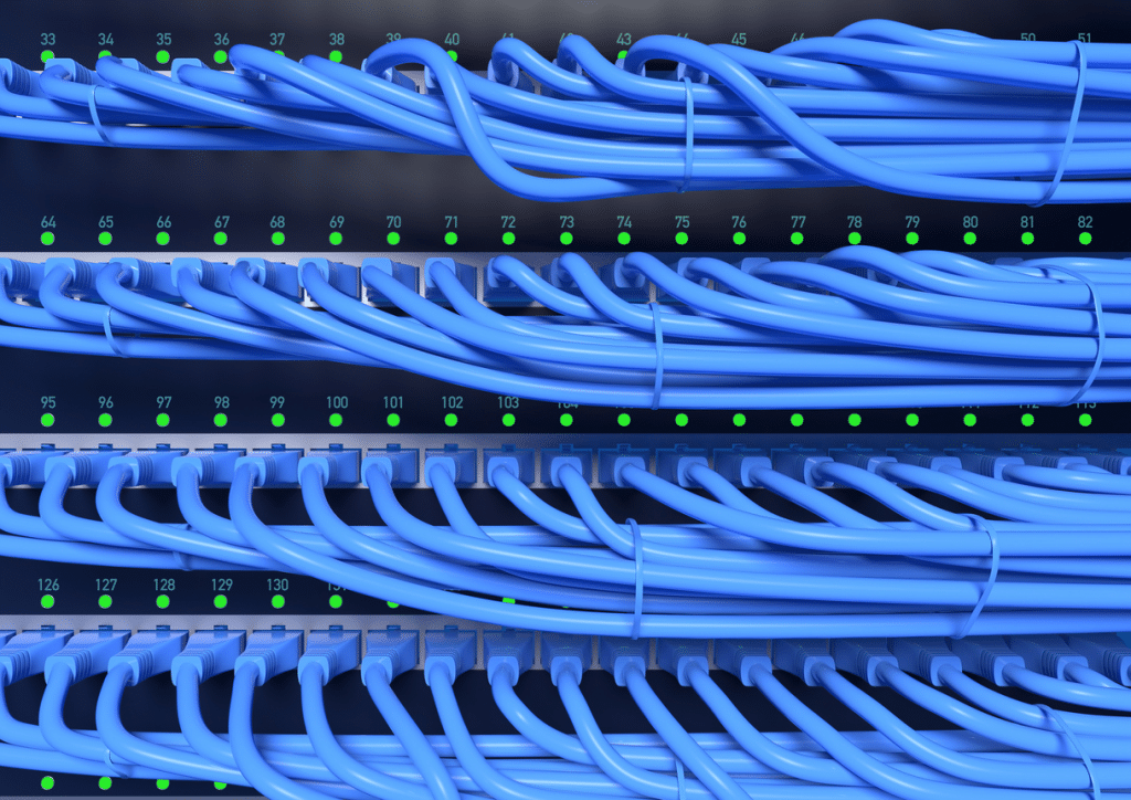A close up of CAT5e and CAT6 blue wires in a data center.