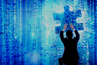 A man is holding a puzzle piece in front of a blue background, symbolising information technology, cloud data and on-premise data backup.